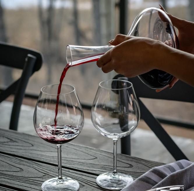 Pouring wine from a crystal decanter